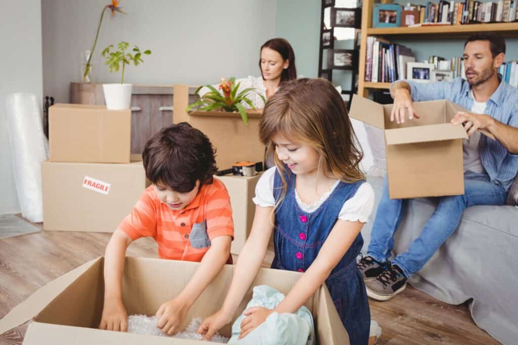A young family unpacking together after the house move